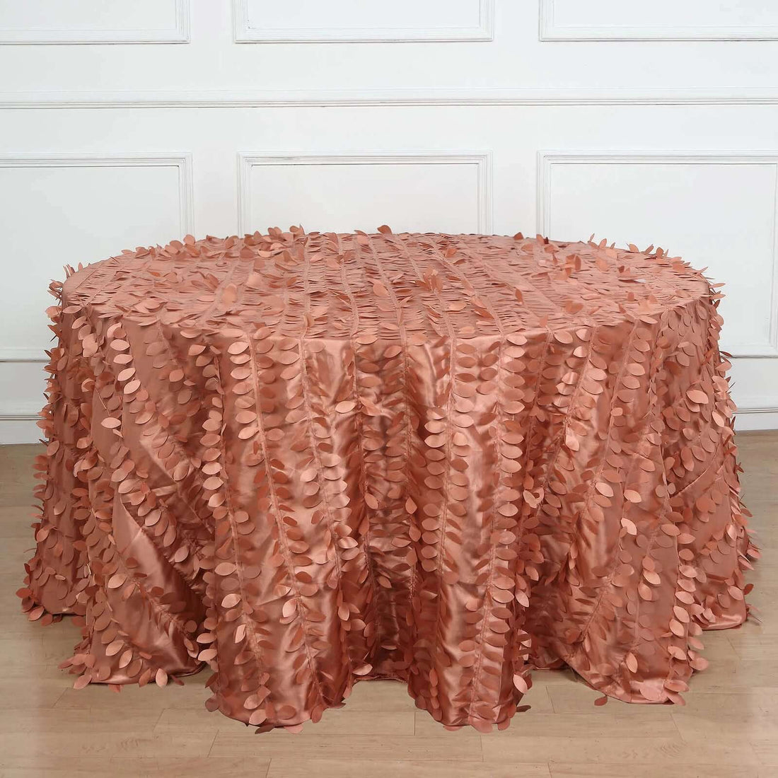 Rose gold sequin tablecloth draped over a round table.