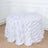 White tablecloth with leaf design draping over a round table