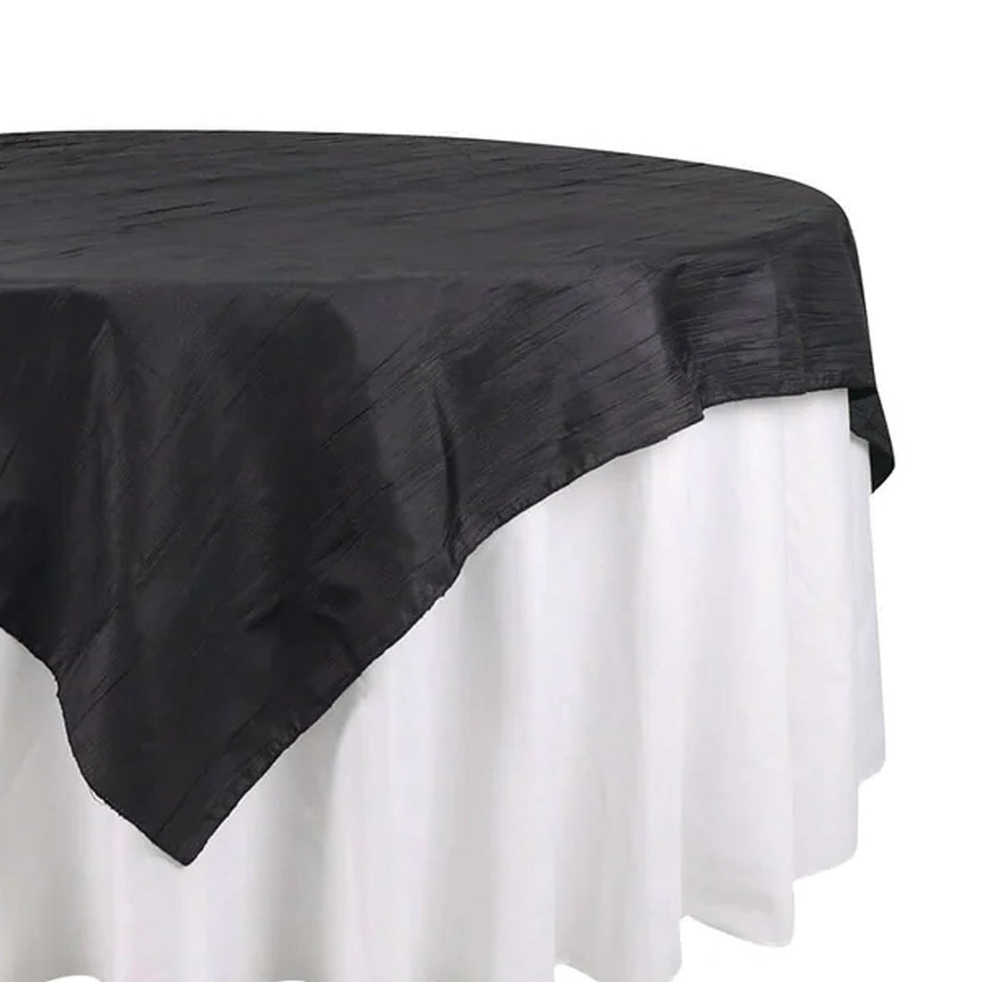 Black tablecloth with textured design, elegantly draped over a white table. 