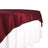 Burgundy tablecloth draped elegantly over a white tablecloth 