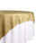 Gold tablecloth draped over a white table 
