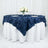 Navy blue tablecloth with floral petal design draped over a round table