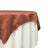 Brown textured tablecloth draped over a table. 