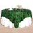 Green leaf-patterned tablecloth draped over a white table.