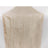 Beige pleated satin fabric draped elegantly on a white backdrop.