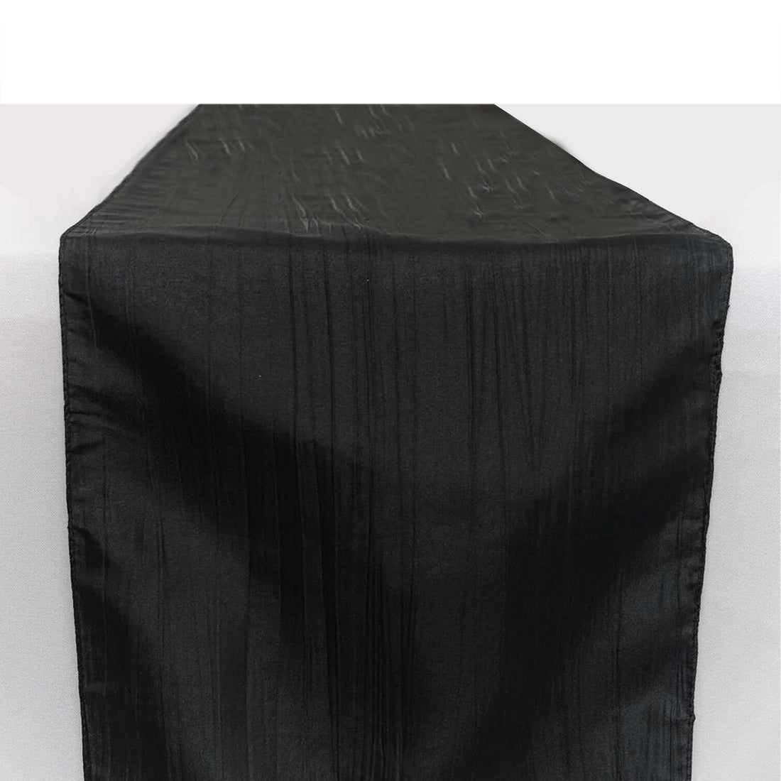 Black table runner with a textured finish on a plain background