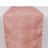 Peach table runner with textured stripes on a plain background.