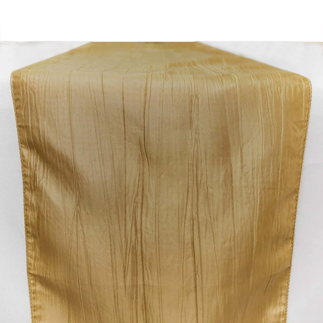 Gold crinkled satin table runner on a white background