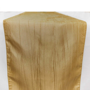 Gold crinkled satin table runner on a white background
