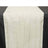 White table runner with textured design on a black table.