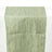 Green textured table runner on a plain backdrop