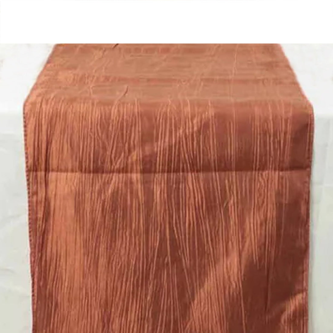 Rust-colored table runner with a textured design on a white background