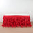 Red ruffled table skirt draped over a rectangular table.