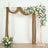 Wedding arch with floral arrangement and draped fabric.