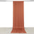 Rust-colored draped fabric on a plain backdrop