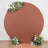 Round terracotta backdrop with flowers arranged at the base.