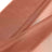 Sheer rust-colored fabric draped elegantly.