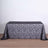 Black lace tablecloth with intricate floral design on a plain backdrop.