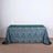 Green patterned tablecloth on a wooden table against a neutral backdrop.