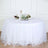 Round table with white tulle skirt and elegant centerpiece.