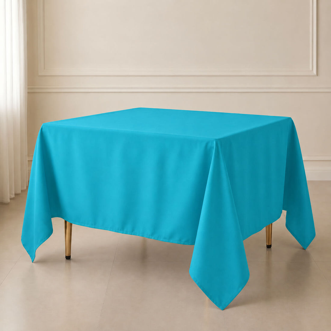 Turquoise wrinkle-resistant table overlay for square tables.