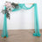 Turquoise draped fabric with floral arrangement on a wooden frame