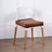 Modern white chair with brown cushion on wooden legs