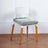Modern chair with white backrest and wooden legs, featuring a soft green cushion.