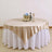 Elegant round table with gold and white tablecloth, perfect for events and dining.