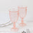 Pink decorative goblets on a white marble table.