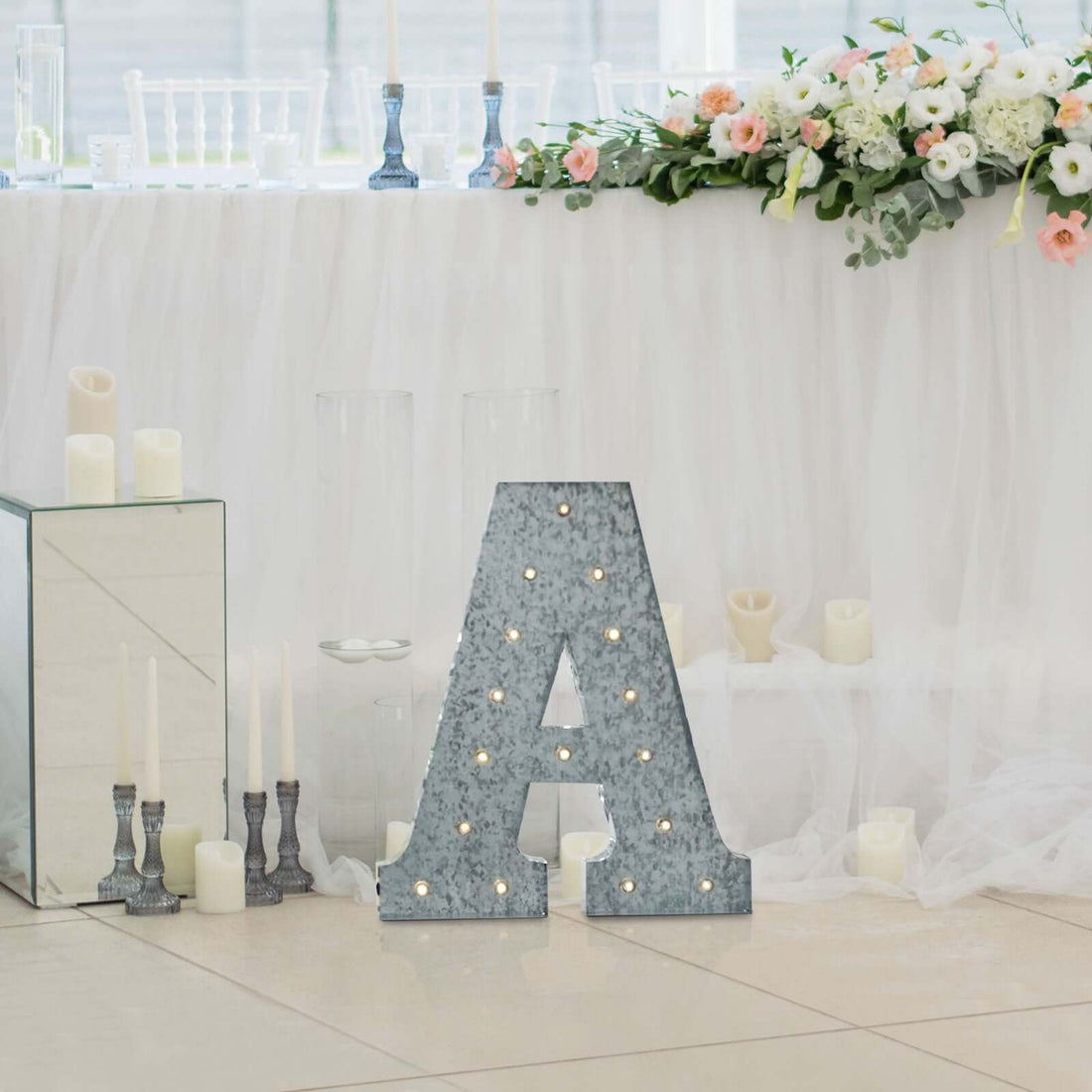 Decorative lighted letter A centerpiece with floral wedding table decor