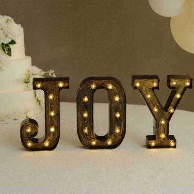 Glowing JOY marquee letters for festive wedding decor