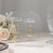Clear table number sign with gold accents, perfect for elegant events.