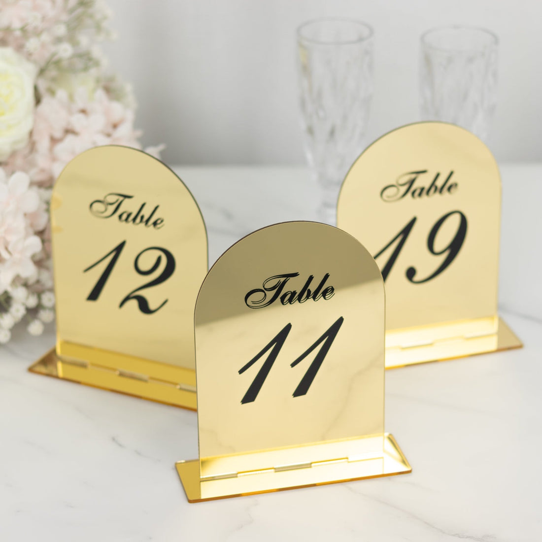 Gold table numbers for weddings or events, featuring numbers 11, 12, and 49.