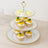 Three-tiered dessert stand with cupcakes and macarons displayed elegantly.
