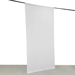 White backdrop fabric hanging from a rod for photography use.