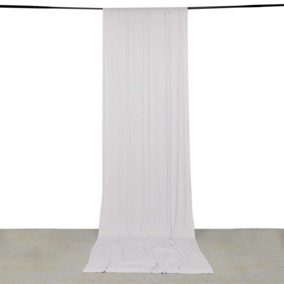 White backdrop fabric draped elegantly in a studio setting.