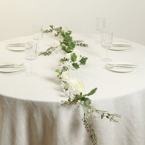 Elegant table setting with floral centerpiece and clear glassware.