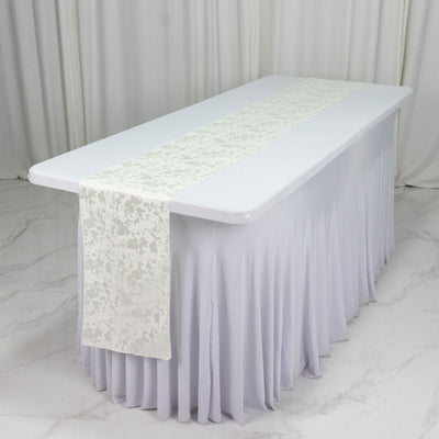 White banquet table with lavender skirt and patterned runner on a marble floor