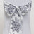 Floral patterned chair sash tied in a bow on a plain background.