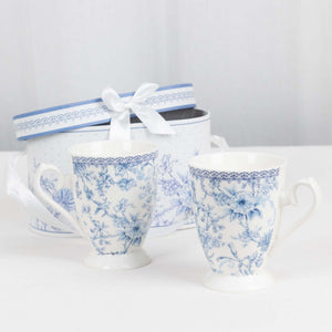 Blue floral patterned mugs with a decorative gift box.