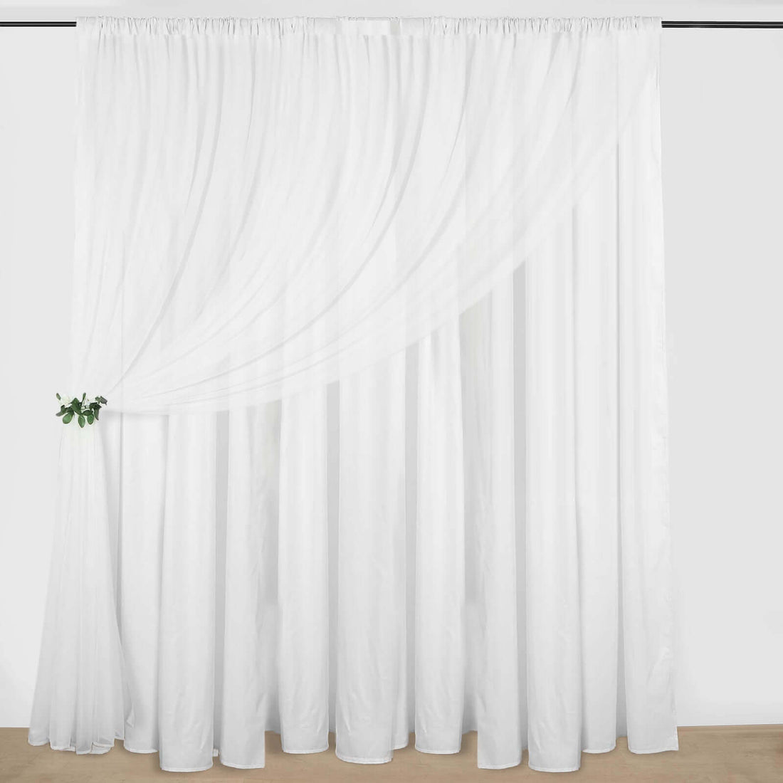 Elegant white sheer curtain with draped design and greenery accent