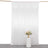 White sheer curtain draped elegantly with floral arrangement in front
