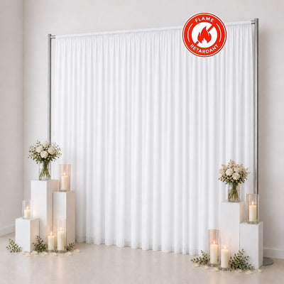 White flame retardant event backdrop curtain with candles and floral decor