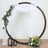 Circular floral arch with drapes and lanterns, perfect for events and weddings.