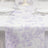 Floral table runner on a dining table with elegant glassware.