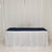 Navy table runner draped over a white tablecloth in a studio setting.