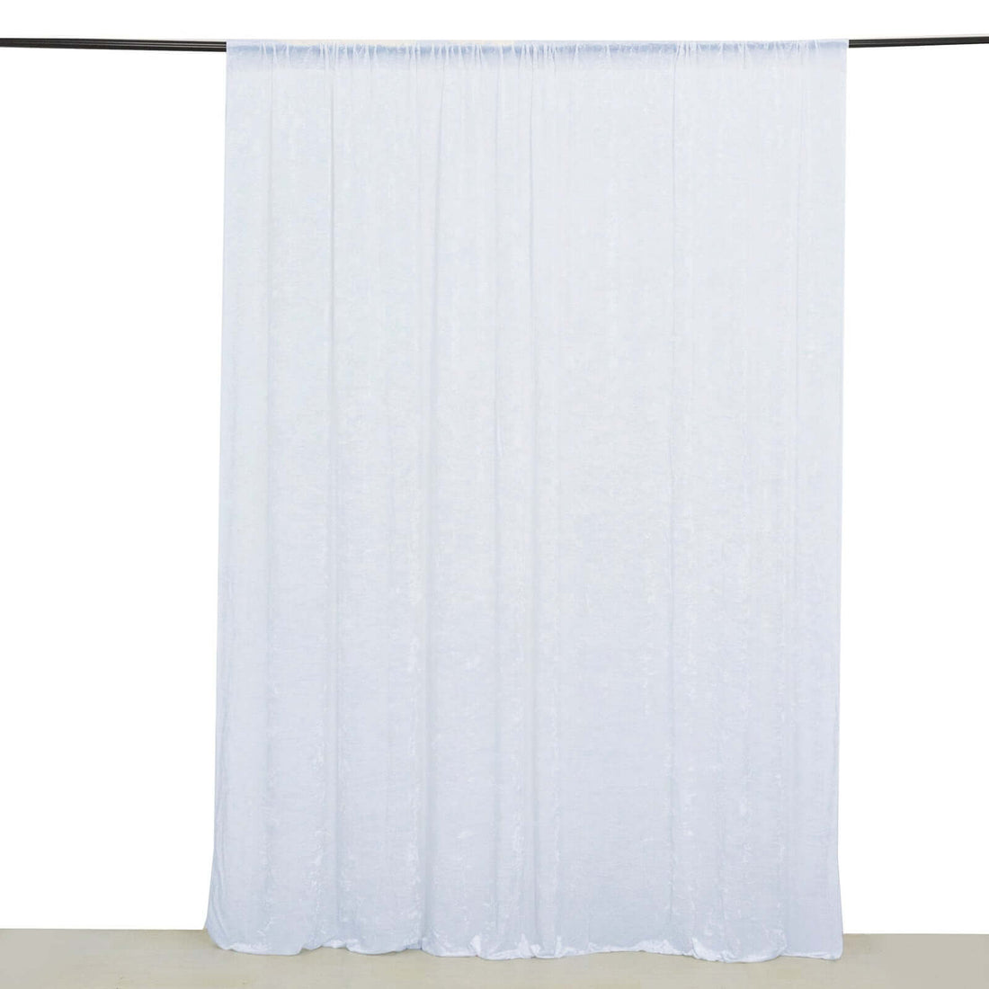 Sheer white curtain panel hanging on a rod
