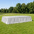 White rectangular banquet table with draped skirt outdoors in a park