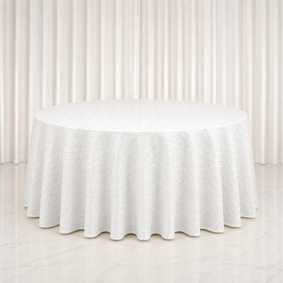 White round table with textured linen tablecloth in elegant neutral room